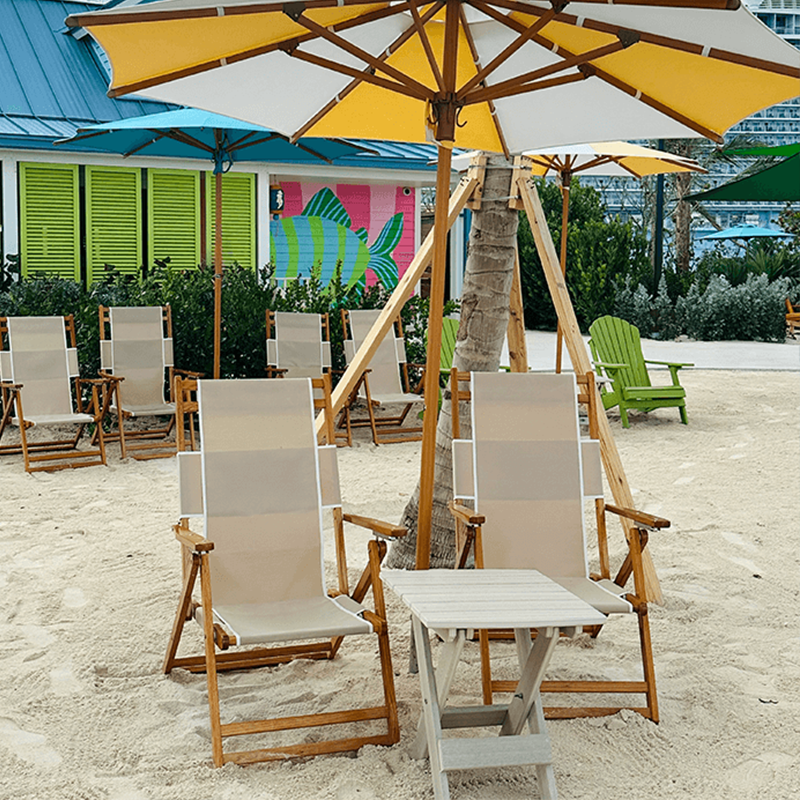Low-profile blue beach chair positioned on the sand overlooking the ocean.